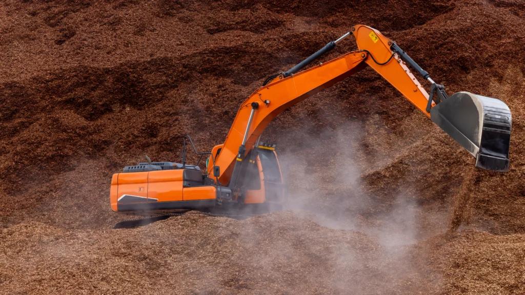 Pelleteuse moderne en fonctionnement sur un chantier, illustrant l’impact environnemental des engins de chantier.